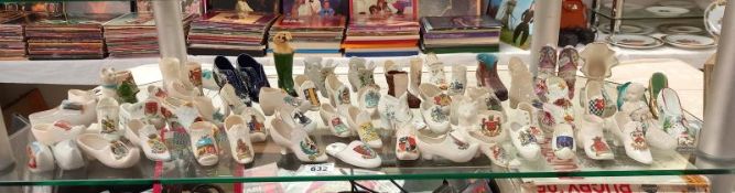 A large selection of crested ware shoe ornaments