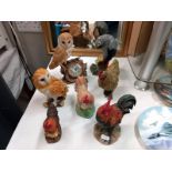 A mixed lot of cockerel and owl figures, plus a grey parrot