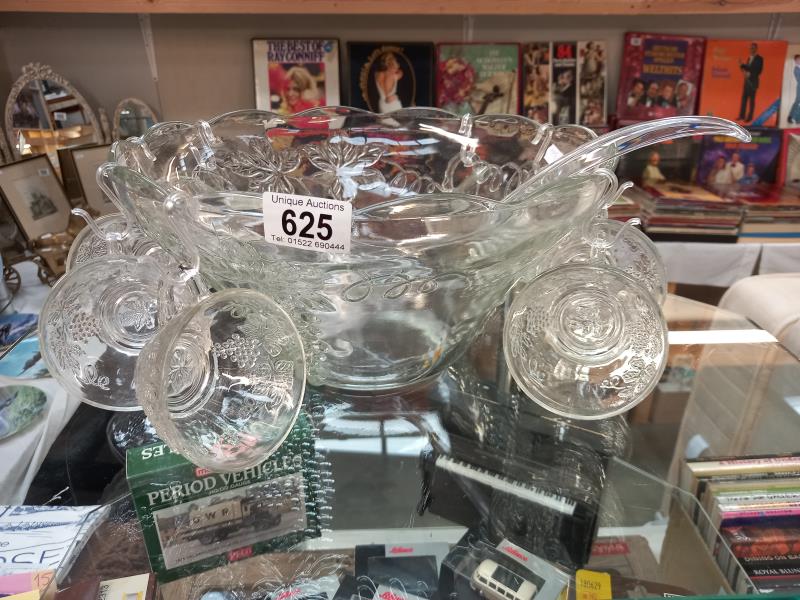 A vintage moulded glass punch bowl with ladle, hooks and 8 punch glasses