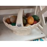 A quantity of polished stone eggs in china basket