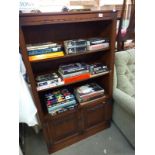 A dark oak bookcase with linen fold cupboard doors 92cm x 33cm x height 153cm