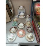 A good assortment of decorative cups and saucers, coffee cans and saucers including Aynsley, Shelley