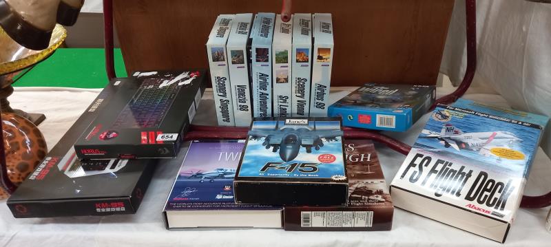 A quantity of boxed Microsoft flight simulator games and 2 keyboards