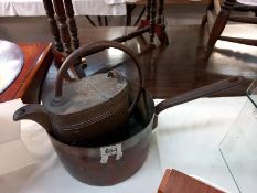 A Victorian copper saucepan with iron handle and vintage brass watering can.