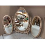 An ornate triple dressing table mirror