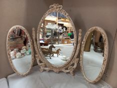 An ornate triple dressing table mirror