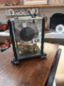 A wrought iron cased Kundo anniversary clock