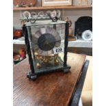 A wrought iron cased Kundo anniversary clock