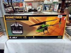 A boxed E Sky honey bee V2 RC helicopter. Looks complete, untested/ unchecked.