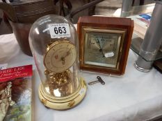 A Bentima floral pattern anniversary clock under glass dome and a vintage barometer.