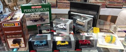 8 boxed Schuco 1/87 scale model cars including Porsche, Mercedes, A C Cobra etc and piano money
