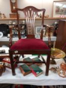 A mahogany carver chair with red velvet seat