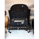An iron fire basket with cast iron fire back