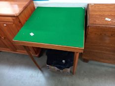 A vintage green felt covered folding card table