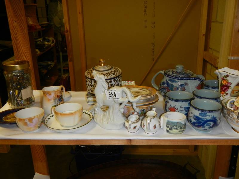 A shelf of assorted ceramics.