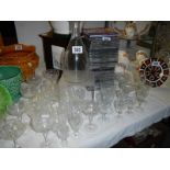 A decanter and several sets of glasses. COLLECT ONLY.