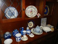 A mixed lot of blue and white plates, jugs, bowls etc., including Willow Pattern.