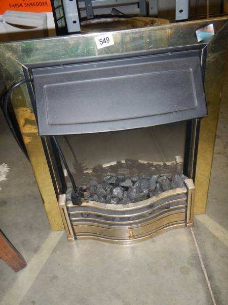 An electric fire with brass surround. COLLECT ONLY.