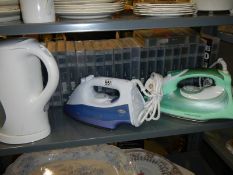 Two good electric irons and a kettle.