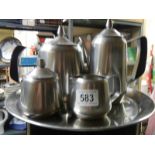 A stainless steel tea set on tray.