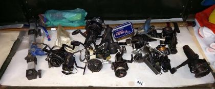 A quantity of fishing reels & a fishing rod