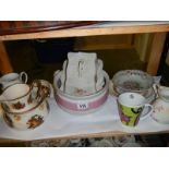 A shelf of assorted ceramics.