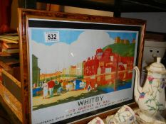 A framed and glazed Whitby railway poster.