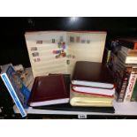 A quantity of postcards, cigarette cards & stamps in albums
