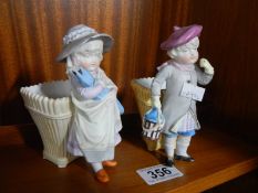 A pair of porcelain boy and girl figures.