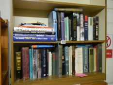 Two shelves of hard back and paper back books.