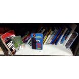 A shelf of hard back & paper back books including Tommy Cooper etc.