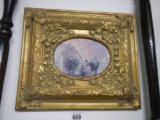 A gilt framed oval painting.