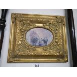 A gilt framed oval painting.