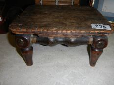 A small antique wooden stool.