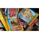 A shelf of assorted games and puzzles.