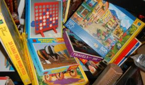 A shelf of assorted games and puzzles.