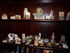 Two shelves of assorted figures etc.,