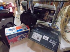 A Panasonic telephone, a vivitar camera, another camera and an LED head lamp.