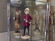 Three meercat figures.