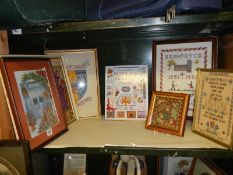 Six framed and glazed cross stitch pictures and a book. COLLECT ONLY.