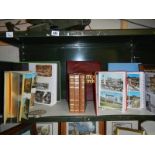 A quantity of photo albums, some with postcards.