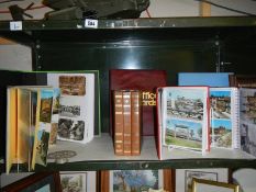 A quantity of photo albums, some with postcards.