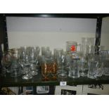 A shelf of drinking glasses including advertising, COLLECT ONLY.