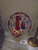 A small Chinese vase and a Chinese plate.