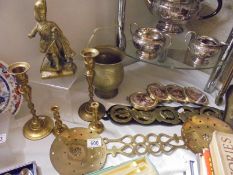 A mixed lot of brass ware including candlesticks, skimmers, horse brasses etc.,