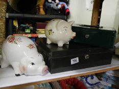 Two metal cash boxes (no keys) and two piggy banks.