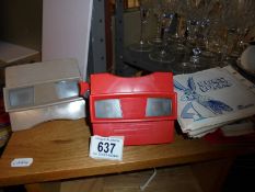 Two 3D Viewmaster viewers with cards.