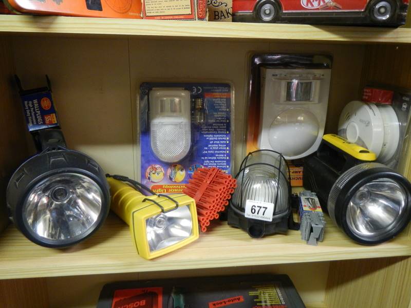 A shelf of assorted torches etc.,