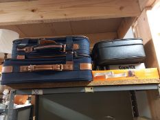 Three vintage suitcases.