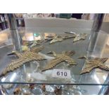 Two sets of brass flying birds.